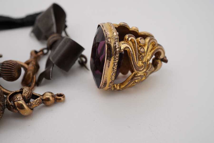 Three assorted yellow metal overlaid and gem set fob seals, including carnelian, largest 26mm, together with a gun metal fob watch, with yellow metal inset plaque.